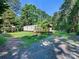 Mobile home with a deck, playground, and wooded area at 10910 Archer Rd, Davidson, NC 28036