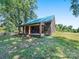 Side view of a rustic wooden home showcasing its unique features at 10910 Archer Rd, Davidson, NC 28036