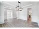 Open dining room with hardwood floors and access to multiple rooms at 2016 Cedar Falls Dr # 7, Waxhaw, NC 28173