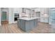 Modern kitchen with gray island, stainless steel appliances, and white cabinets at 2016 Cedar Falls Dr # 7, Waxhaw, NC 28173