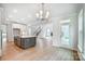 Large kitchen island with gray cabinets, quartz countertops, and sink at 2016 Cedar Falls Dr # 7, Waxhaw, NC 28173