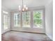 Bright dining room with hardwood floors, chandelier, and backyard view at 2016 Cedar Falls Dr # 7, Waxhaw, NC 28173