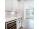 White kitchen cabinets with quartz countertops and wine cooler at 2016 Cedar Falls Dr # 7, Waxhaw, NC 28173
