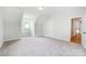 Well-lit bedroom with carpet flooring, and access to hallway at 2016 Cedar Falls Dr # 7, Waxhaw, NC 28173