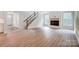 Open living room with hardwood floors, fireplace and staircase at 2016 Cedar Falls Dr # 7, Waxhaw, NC 28173
