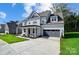 Two-story house with gray siding, a covered porch, and a two-car garage at 2016 Cedar Falls Dr # 7, Waxhaw, NC 28173