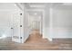Bright hallway with hardwood floors and French doors leading to other rooms at 2016 Cedar Falls Dr # 7, Waxhaw, NC 28173