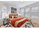Spacious bedroom with orange bedding and window blinds at 512 Lockwood Creek Dr # 29, Charlotte, NC 28208