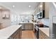 Modern kitchen with gray cabinets and white backsplash at 512 Lockwood Creek Dr # 29, Charlotte, NC 28208