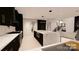 Modern kitchen with large island and dark cabinetry at 14007 Point Lookout Rd, Charlotte, NC 28278