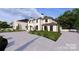 Elegant home with a large driveway and lush landscaping at 14007 Point Lookout Rd, Charlotte, NC 28278