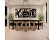 Formal dining room with a chic black and gold dining set and statement artwork at 14007 Point Lookout Rd, Charlotte, NC 28278