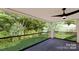 Covered porch overlooking backyard with glass railings at 14007 Point Lookout Rd, Charlotte, NC 28278