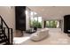 Spacious living area with a modern fireplace and wall-to-wall windows offering scenic views at 14007 Point Lookout Rd, Charlotte, NC 28278