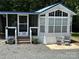 Quaint single-wide mobile home with screened porch at 114 Walnut Cir, New London, NC 28127