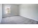 Spacious bedroom with grey carpeting and a large window at 14447 Waterlyn Dr, Charlotte, NC 28278