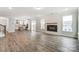 Living room with a modern fireplace, wood-look flooring, and open concept design at 130 Summerhill Dr # 16, Mooresville, NC 28115