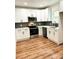 Modern kitchen with white cabinets and stainless steel appliances at 115 Palmer St, Shelby, NC 28150