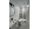 Modern bathroom with gray tile shower and round mirror at 115 Palmer St, Shelby, NC 28150