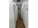 Long hallway with light walls and wood-look vinyl flooring at 115 Palmer St, Shelby, NC 28150