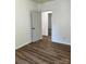 Simple bedroom with wood-look vinyl flooring and access to another room at 115 Palmer St, Shelby, NC 28150