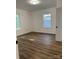 Well-lit bedroom with two windows and vinyl flooring at 115 Palmer St, Shelby, NC 28150