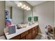 Clean bathroom with a double vanity and large mirror at 8714 Brideswell Ln, Charlotte, NC 28278