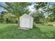 White storage shed in a grassy backyard setting at 8714 Brideswell Ln, Charlotte, NC 28278