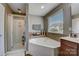 Bathroom with corner soaking tub and separate shower at 8714 Brideswell Ln, Charlotte, NC 28278