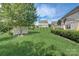 Landscaped backyard with shed and partial home view at 8714 Brideswell Ln, Charlotte, NC 28278