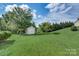 Large backyard with shed and grassy area, perfect for outdoor activities at 8714 Brideswell Ln, Charlotte, NC 28278