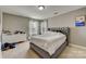 Bedroom with a gray upholstered bed and dresser at 8714 Brideswell Ln, Charlotte, NC 28278
