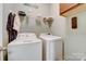 Laundry room with washer, dryer, and shelving at 8714 Brideswell Ln, Charlotte, NC 28278