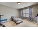 Small bedroom with a twin bed and patterned curtains at 8714 Brideswell Ln, Charlotte, NC 28278