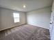 Bright bedroom with carpet flooring and a window offering natural light at 414 Apex Cir, Shelby, NC 28152