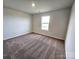 Well-lit bedroom with carpet flooring and a window at 414 Apex Cir, Shelby, NC 28152
