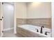 Bathroom with a large soaking tub and wood-like tile at 4198 Pickering Dr, Hickory, NC 28602