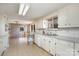Kitchen with white cabinets and a view of the living room at 149 Pine Hollow Dr, Dallas, NC 28034