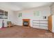 Sunroom with a fireplace, carpet, and built-in shelving at 149 Pine Hollow Dr, Dallas, NC 28034