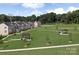 Aerial view of townhouses with a community green space at 1979 Tupelo Grove Ln, Gastonia, NC 28054