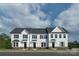 Three-unit townhome exterior with white siding and stone accents at 1979 Tupelo Grove Ln, Gastonia, NC 28054