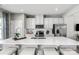 Modern kitchen with white cabinets, quartz countertops, and stainless steel appliances at 1979 Tupelo Grove Ln, Gastonia, NC 28054