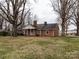 Brick house with a grassy yard and trees at 12560 Highway 601 Hwy, Midland, NC 28107