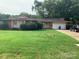 Brick ranch house with attached garage and a large yard at 9400 Sandburg Ave, Charlotte, NC 28213
