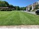 Street view of a well-maintained lawn and upscale townhouses at 9400 Sandburg Ave, Charlotte, NC 28213