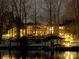 Exterior of the house at night with lights, snow, and lake view at 179 Appian Way, Shelby, NC 28150