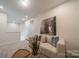 Upstairs sitting area with comfy sofa and neutral decor at 5919 Wetlands Aly, Charlotte, NC 28215