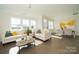 Bright and airy living room with white sofas and access to dining area at 5919 Wetlands Aly, Charlotte, NC 28215