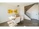 Dining area with light wood table and four chairs, near staircase at 5919 Wetlands Aly, Charlotte, NC 28215