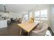 Spacious dining area with light wood table and chairs, open to living area at 5919 Wetlands Aly, Charlotte, NC 28215